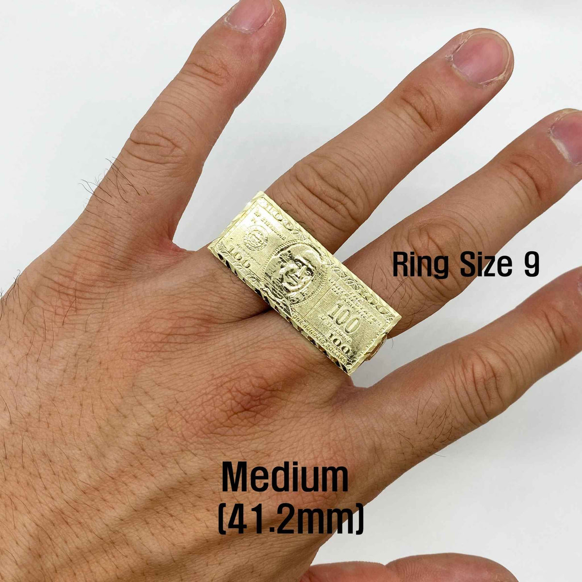 a hand wearing 10k Gold ring with a dollar bill design with sizes. 
