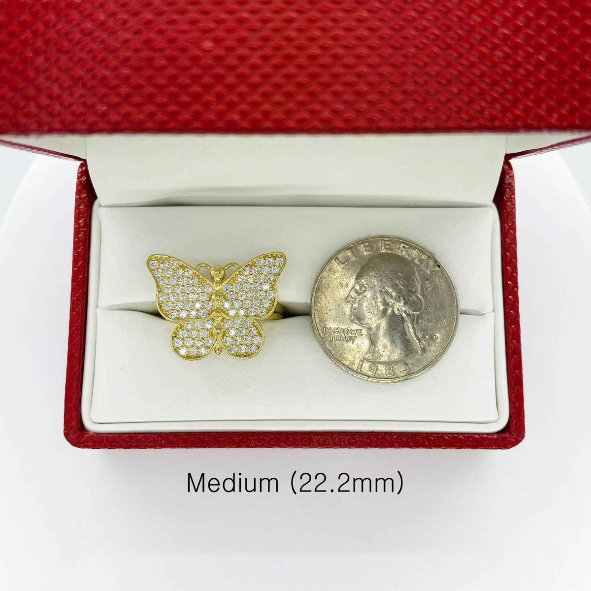 10k Gold butterfly ring in a red jewelry box with a coin next to it for comparison
