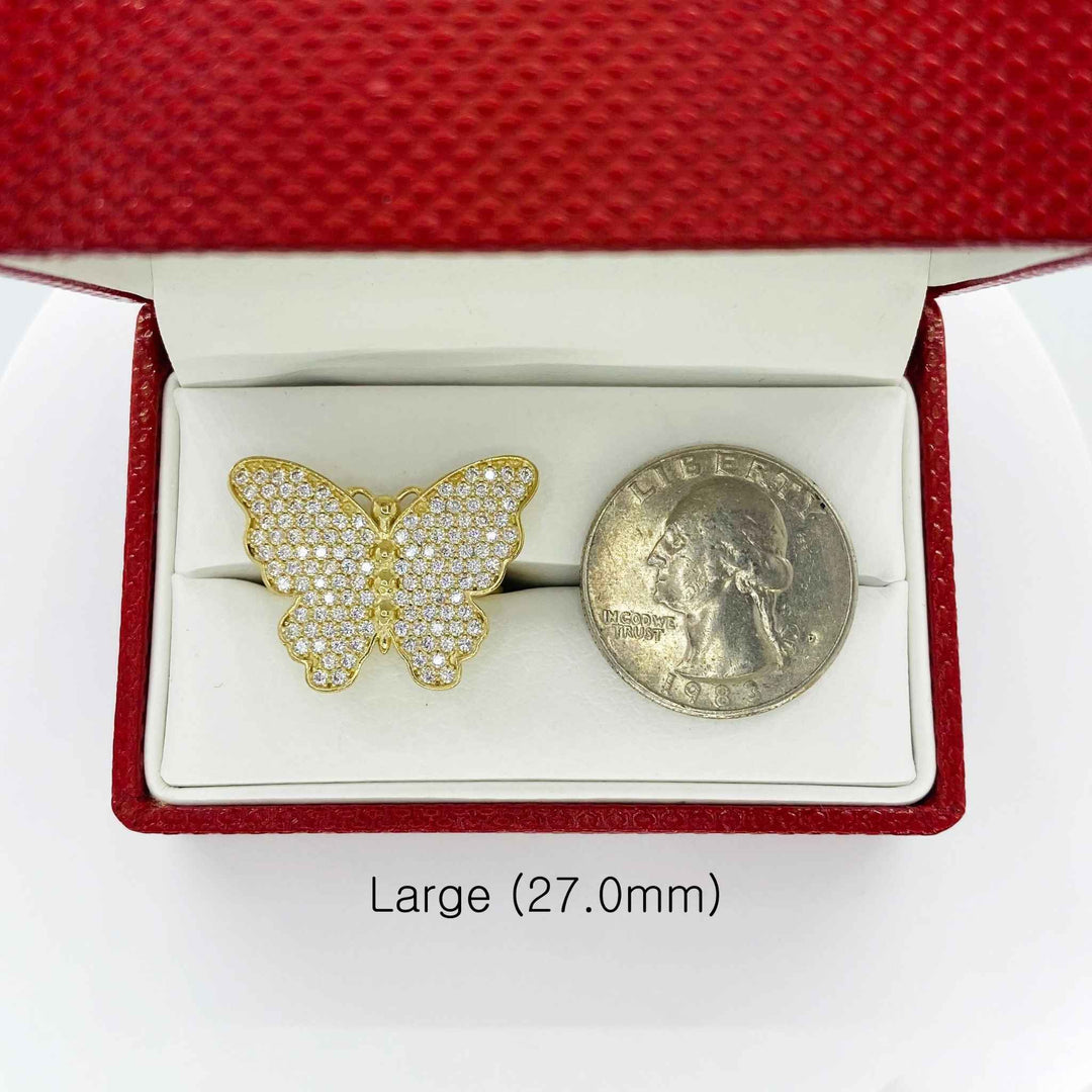 10k Gold butterfly ring in a red jewelry box next to a quarter for scale on a white background