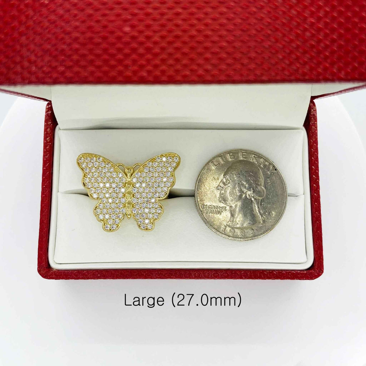 10k Gold butterfly ring in a red jewelry box next to a quarter for scale on a white background