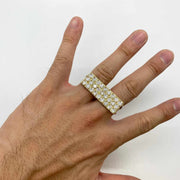 Hand wearing a 10k gold two finger ring with rectangular design on a white background