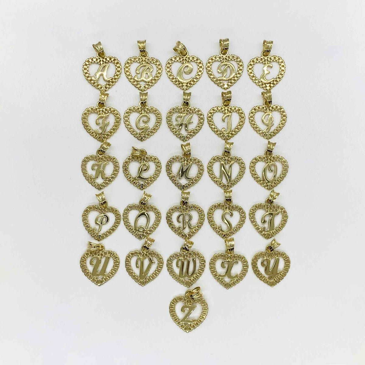 10k yellow gold alphabet initial letter Rollie heart pendants displayed on white background.