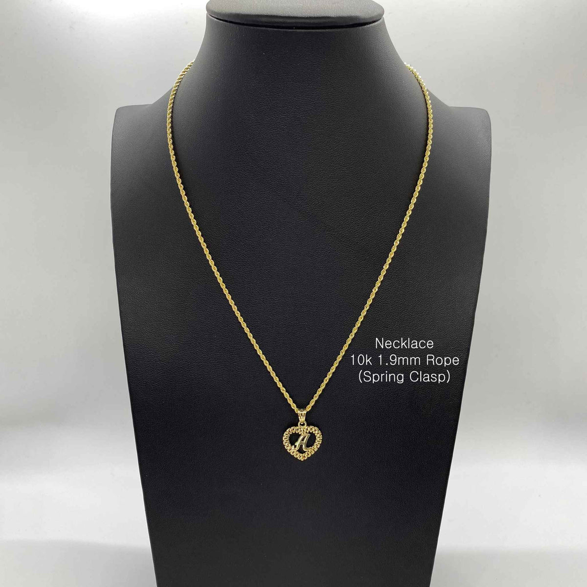 10k yellow gold initial letter A Rollie heart pendant necklace displayed on black bust.