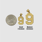 Size chart comparing small and medium gold number 9 pendants to a US quarter.
