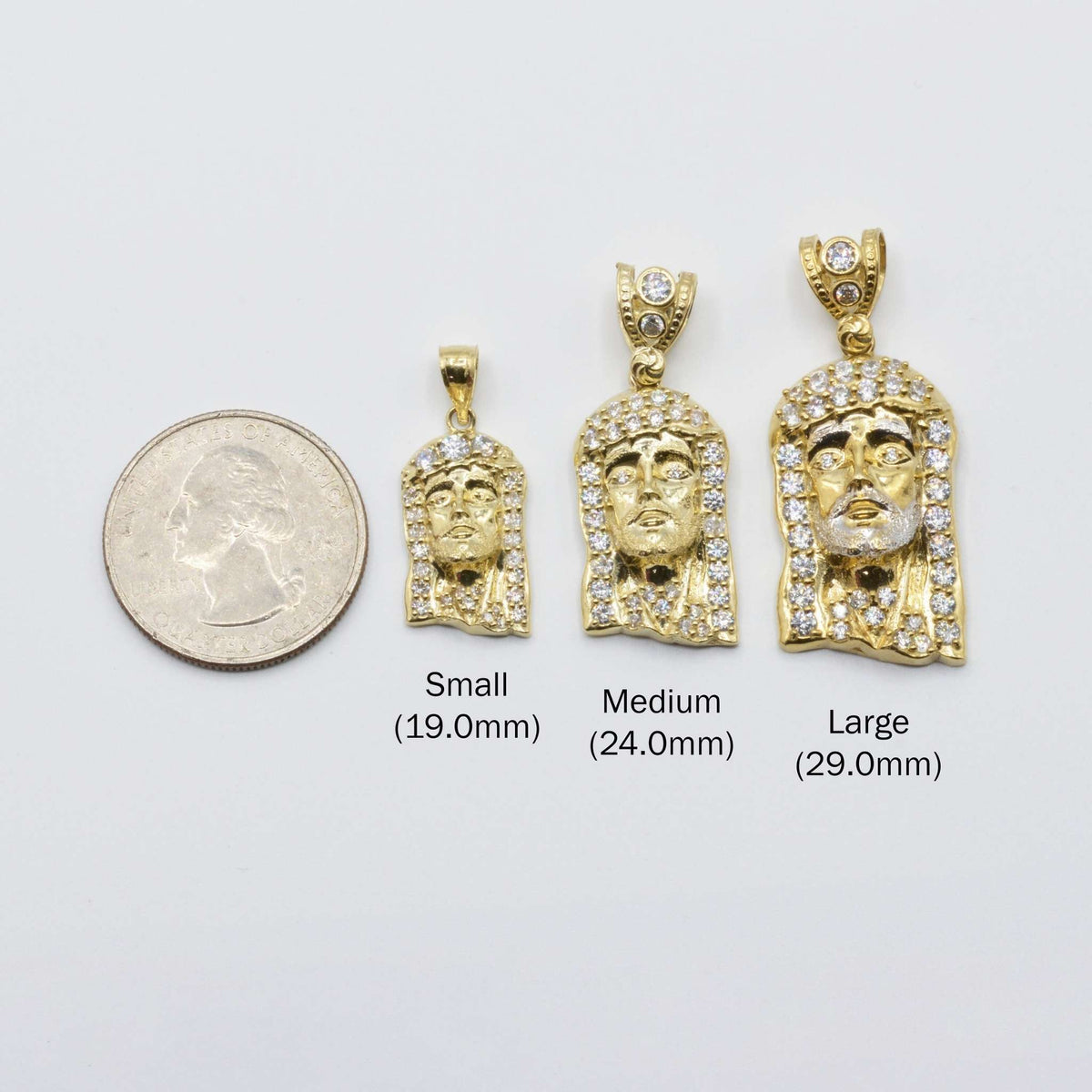 Small, medium, and large 10k gold Jesus pendants compared with a US quarter.