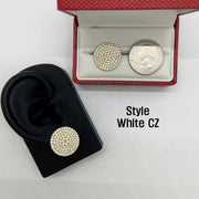 White CZ stud earring on an ear model beside a boxed earring and quarter.