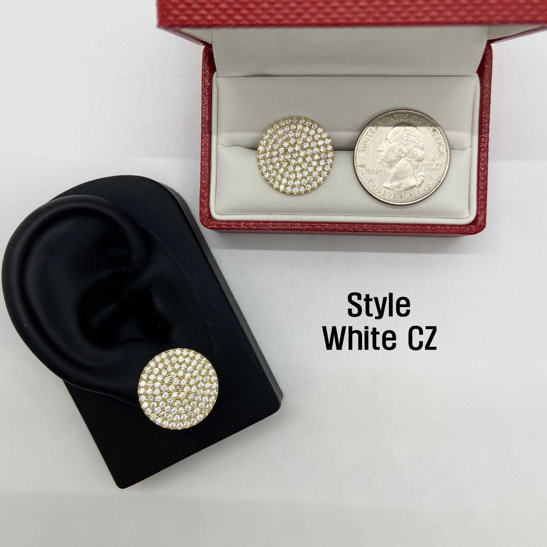 White CZ stud earring on an ear model beside a boxed earring and quarter.