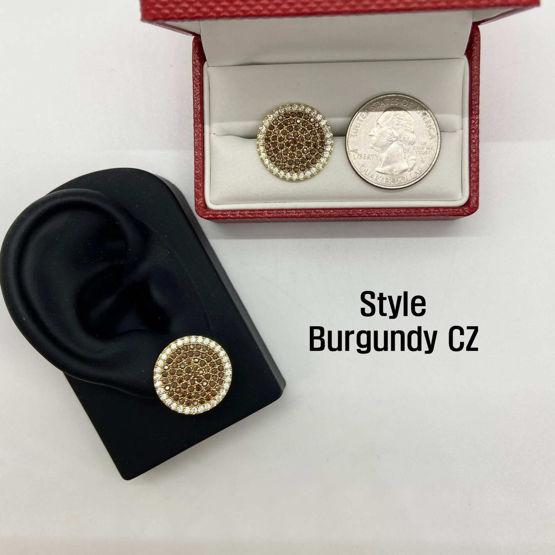 Burgundy CZ stud earring on an ear model beside a boxed earring and quarter.
