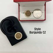 Burgundy CZ stud earring on an ear model beside a boxed earring and quarter.