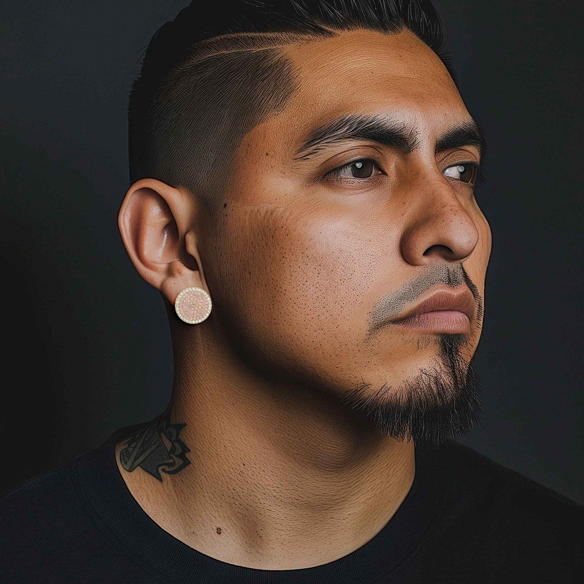 Man wearing 10k yellow gold jumbo round stud earrings with white cubic zirconia.