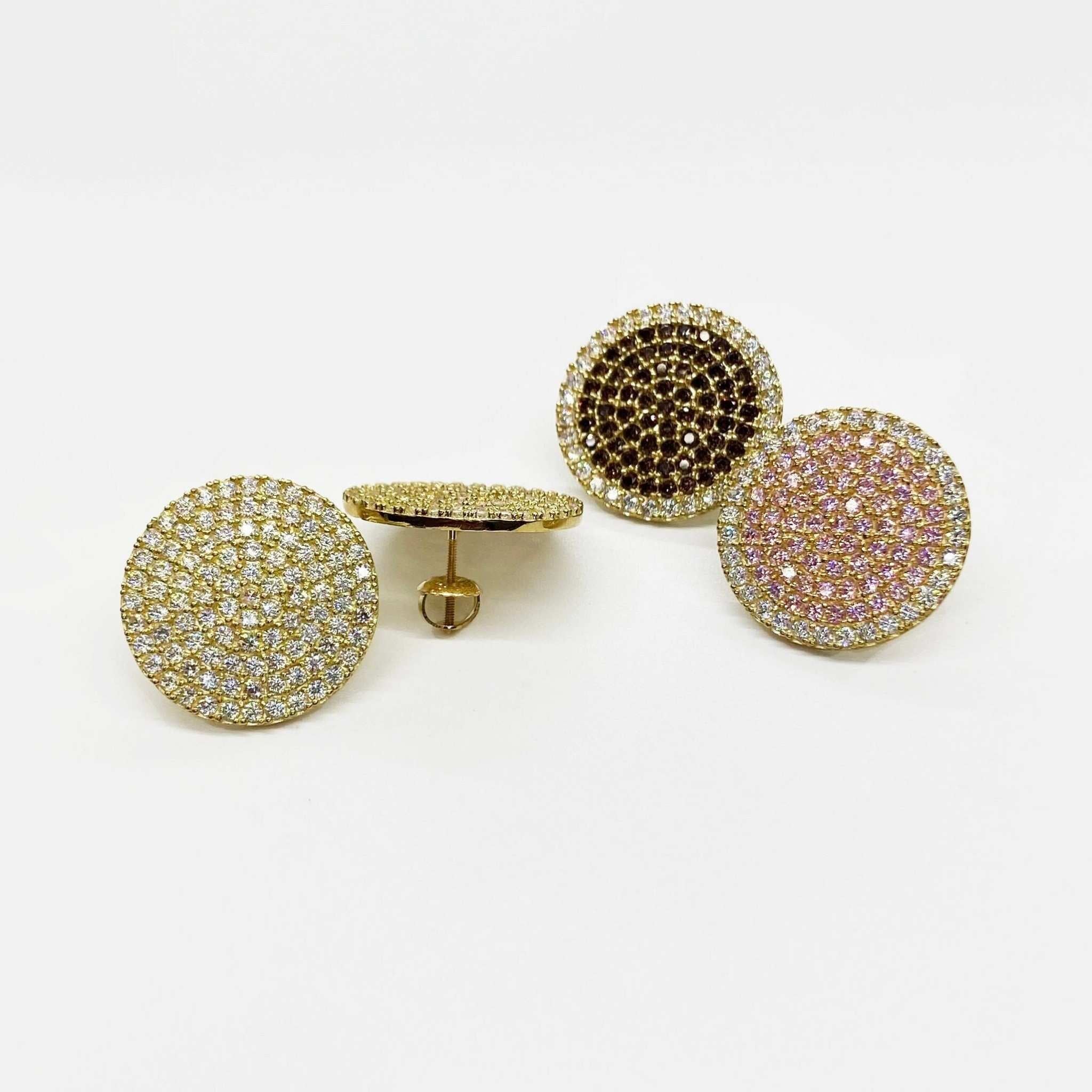 Three large round gold stud earrings paved with white, pink, and burgundy stones.