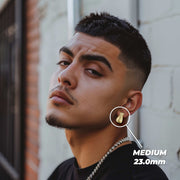 Man wearing medium 23.0mm 10k gold moneybag diamond-cut stud earrings.