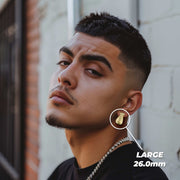 Man wearing large 26.0mm 10k gold moneybag diamond-cut stud earrings.