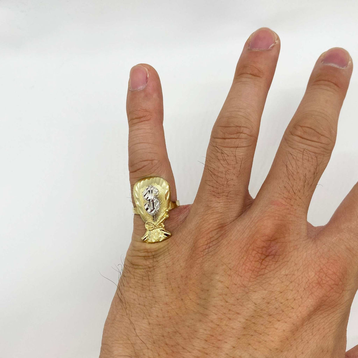 10k Gold ring with a Kali Loot Moneybag design on a person's finger against