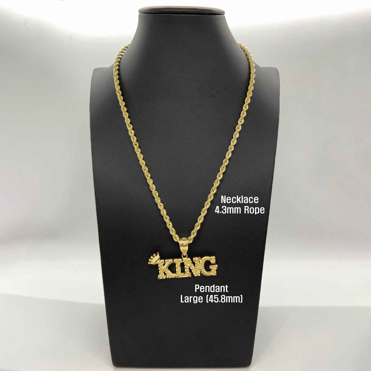 Large 45.8mm 10k gold King crown pendant necklace on a black mannequin bust.