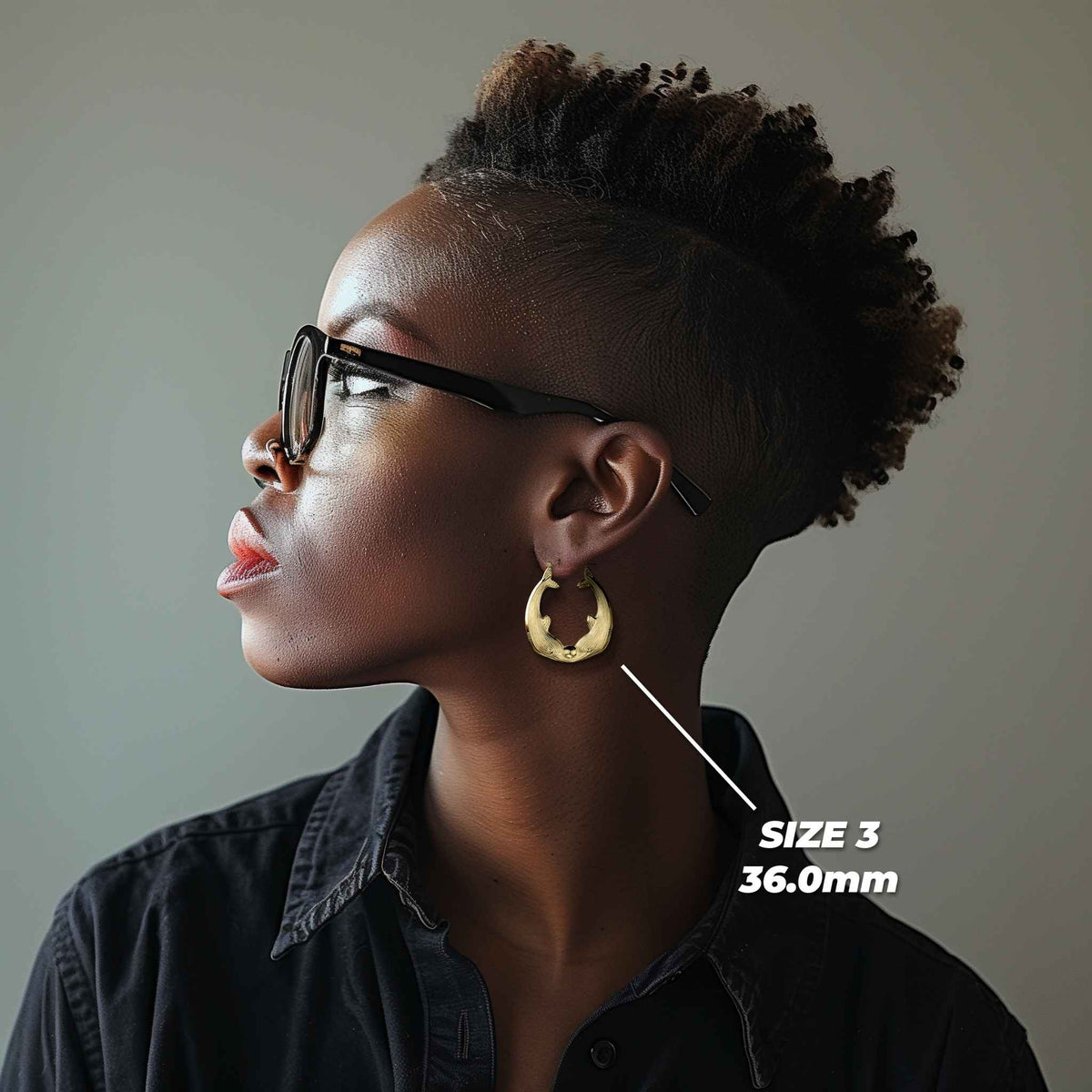 Side profile of a model wearing the 36.0mm Size 3 gold kissing dolphin hoop.
