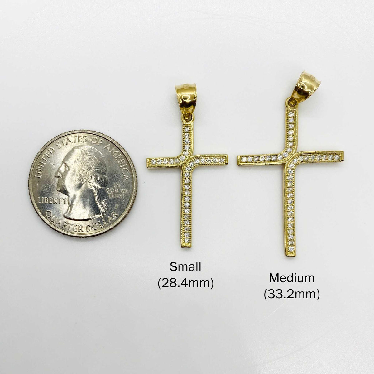 Small and Medium 10k gold iced-out L-cross CZ pendants shown beside a quarter.