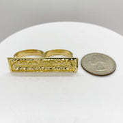 10k Gold two finger rectangular ring with Last Supper design next to a quarter. 
