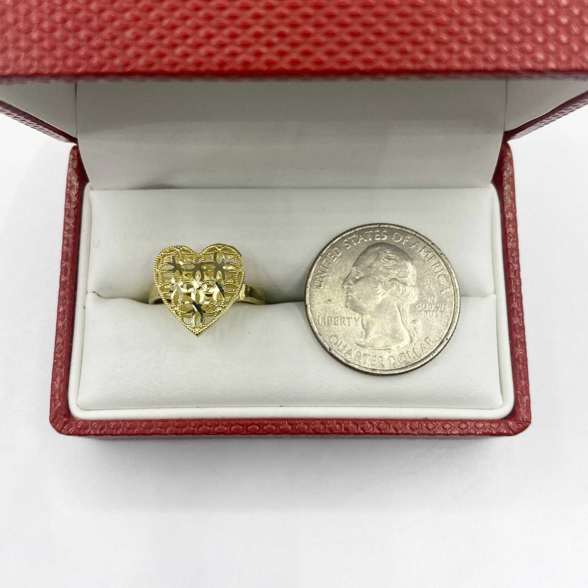 10k Gold heart shaped ring and silver dollar coin in a red jewelry box 