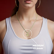 Model wearing a medium 17.5mm gold heart pendant necklace labeled with medium sizing.