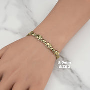 9.0mm Size 2 10K yellow gold elephant link bracelet displayed on a wrist