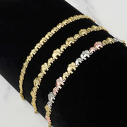 Three 10K gold elephant link bracelets in various widths displayed on black velvet.
