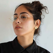 Model wearing 10k gold butterfly-shaped stud earrings with cubic zirconia.