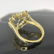 10k Gold ring with intricate design back view on a reflective black surface
