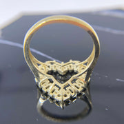 10k Gold ring with heart shape design back view on a reflective black surface