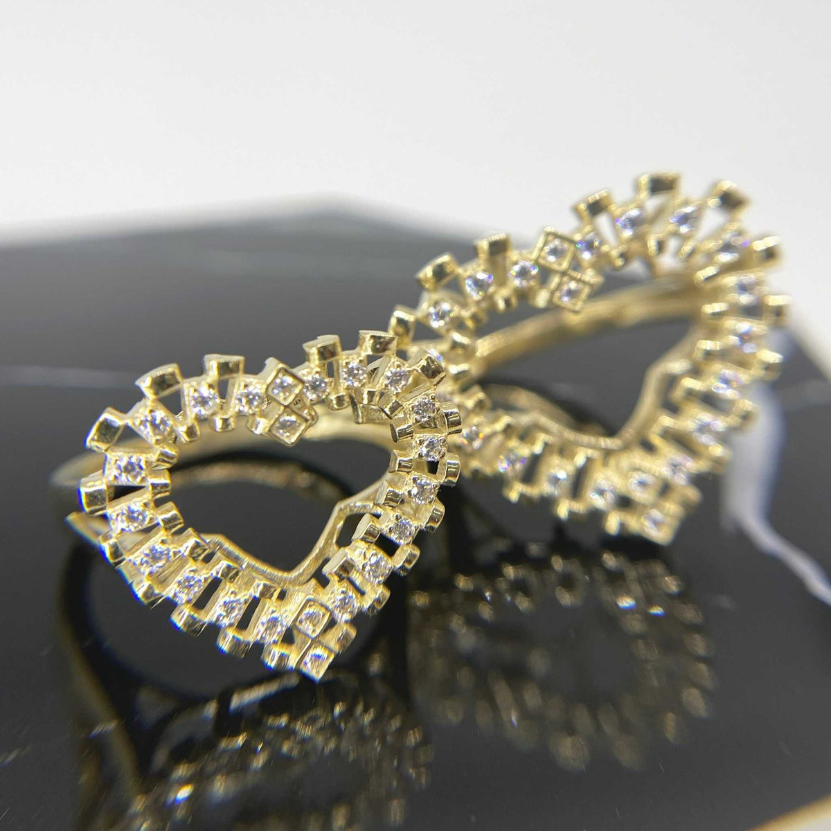 10k Gold Luxe Rollie heart ring with Cubic Zirconia accents on a reflective surface 