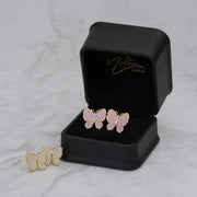 Pink and white gold butterfly stud earrings displayed in a Nolters Gold jewelry box.