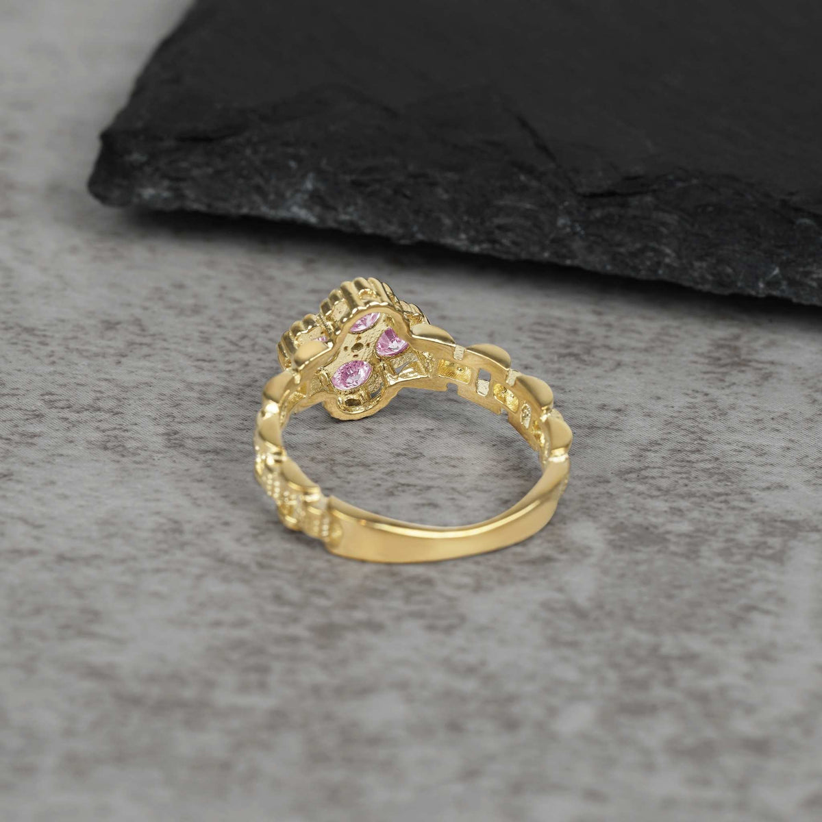 Back view of 10k gold luxe square rollie band ring with pink cubic zirconia.
