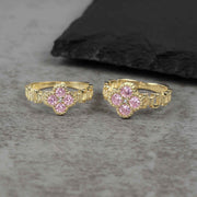 Two sizes of 10k gold luxe clover rollie band rings with pink cubic zirconia.
