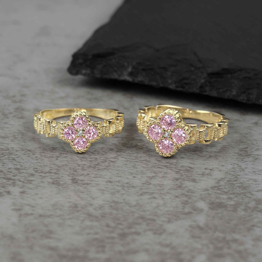 Two sizes of 10k gold luxe clover rollie band rings with pink cubic zirconia.