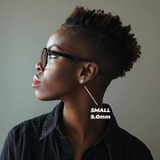Profile view of a model wearing the small 9.0mm gold clover stud earring.