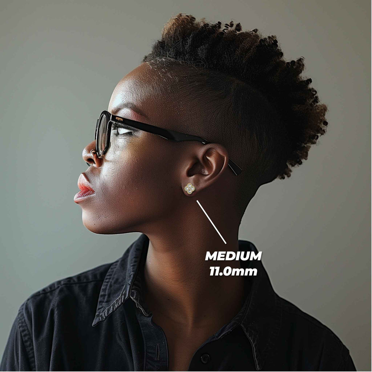 Profile view of a model wearing the medium 11.0mm gold clover stud earring.
