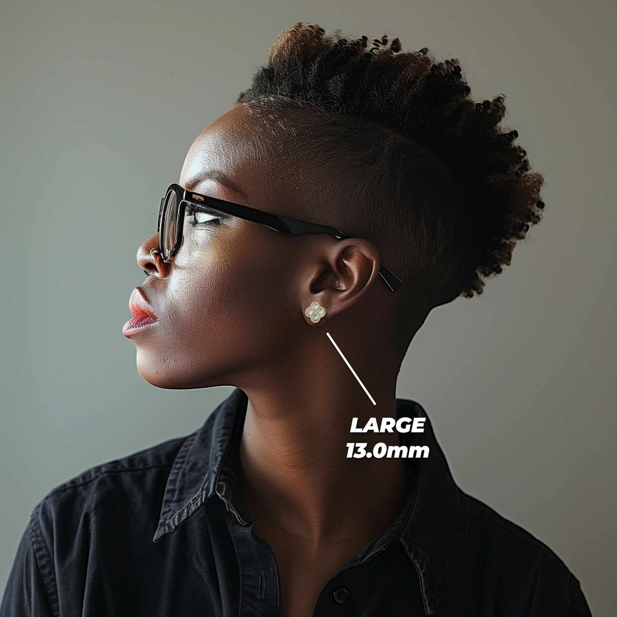 Lifestyle shot of a model wearing the large 13.0mm clover-style gold earring.