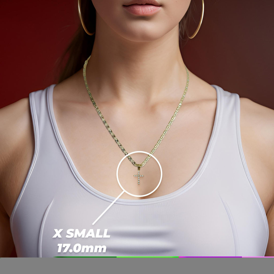 Woman wearing a white top and gold necklace highlighting an x-small cross pendant.
