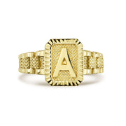 Gold initial ring with letter A displaying the textured rectangular bezel design.