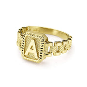 Flat-lay view of 10k gold luxe rectangular signet ring with presidential-style rollie band.