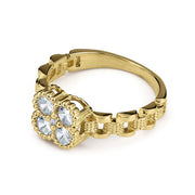 Gold clover-shaped ring with clear gemstones on a clean white background.