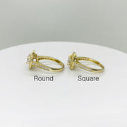 Two 10k gold rings with round and square stone shapes side view on a white background