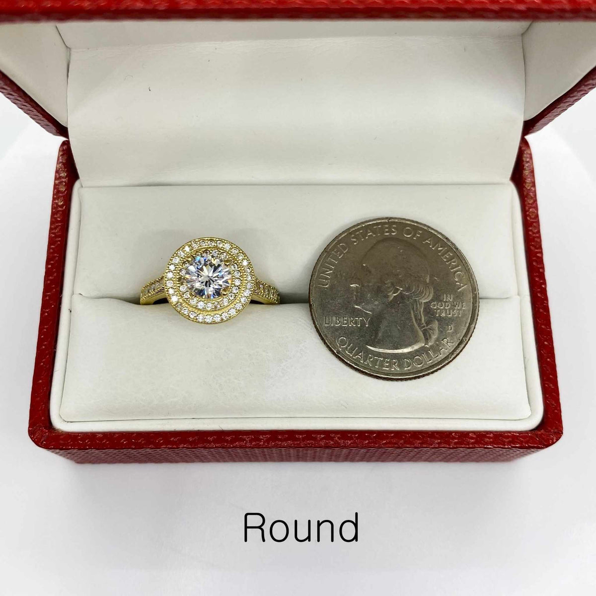 10k Gold ring with a cubic zirconia next to a U.S. quarter dollar coin for comparison 