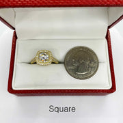 10k square shape Gold ring with a cubic zirconia next to a quarter in an open red jewelry box.
