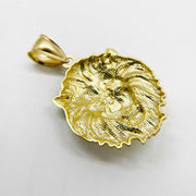Angled close-up of a textured yellow gold lion head pendant against a white background.