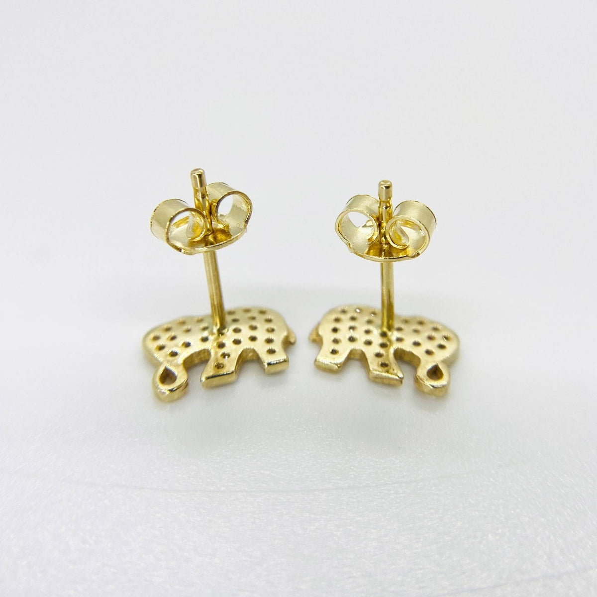 Reverse side of 10k gold elephant stud earrings with secure push-back closures.