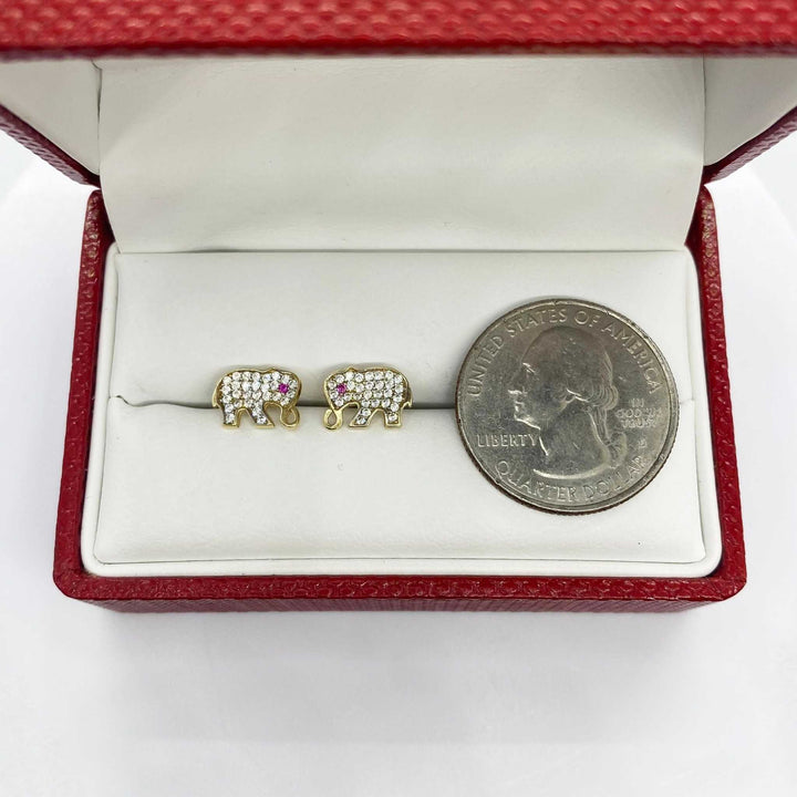 10k gold elephant stud earrings with cubic zirconia in a jewelry box with a quarter.