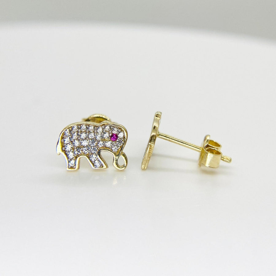 10k gold elephant stud earrings with cubic zirconia and a red eye on white background.