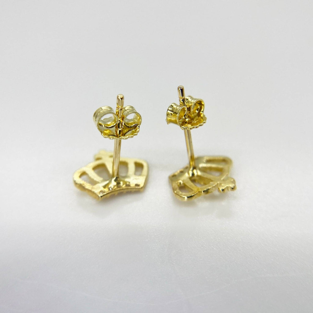 Rear view of 10k gold crown stud earrings highlighting the intricate crown outline and push-back closures.