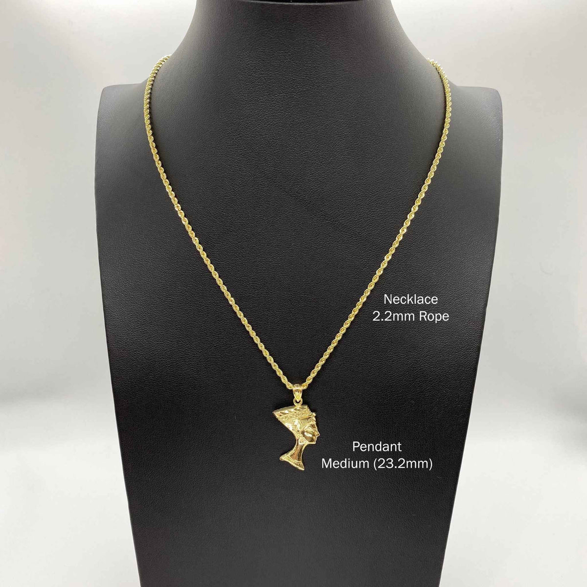 Medium-sized 10k gold Queen Nefertiti head charm styled on a 2.2mm rope chain over a dark display bust.